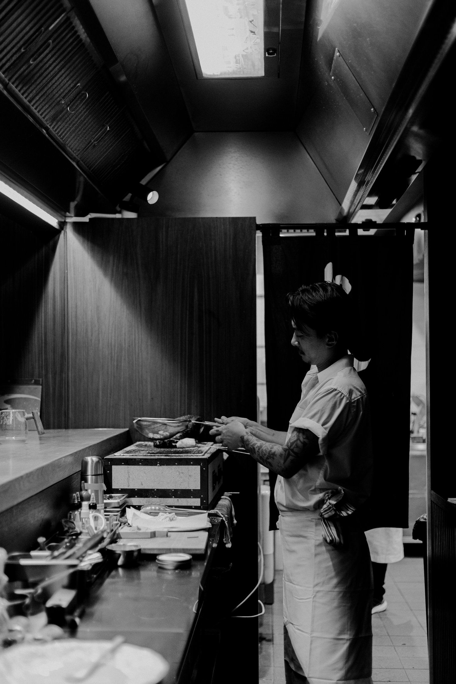 Chef Masa Hisaeda cooking at a live teppan station